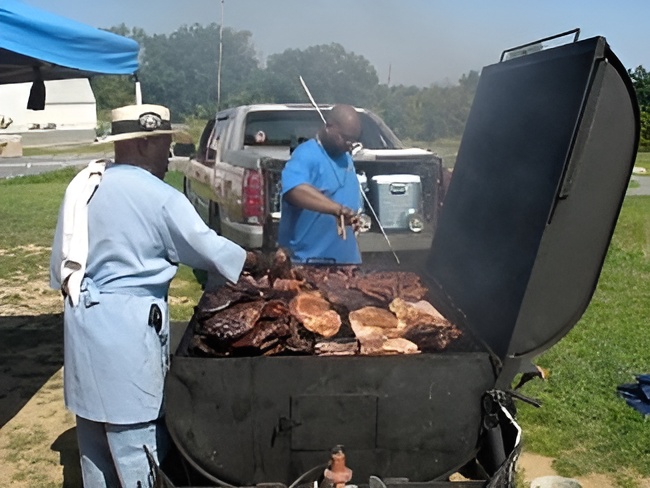 Two Men Grilling Meat